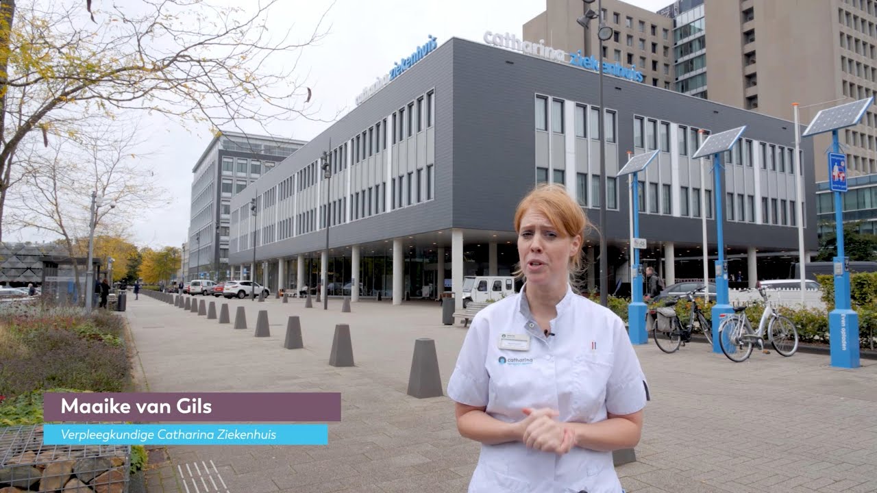 Verpleegkundige Maaike van Gils met mondkapje staat buiten het Catharina Ziekenhuis. Fietsen en bomen op de stoep.